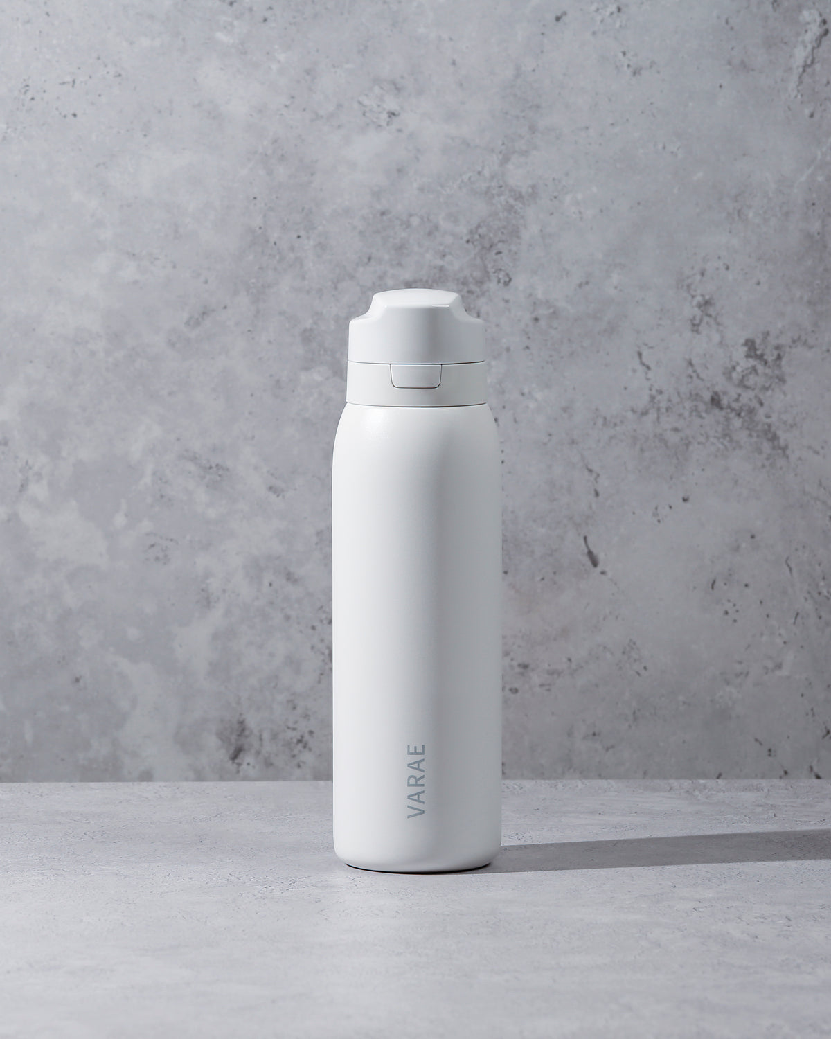 White VARAE Pure filtered water bottle on a neutral background