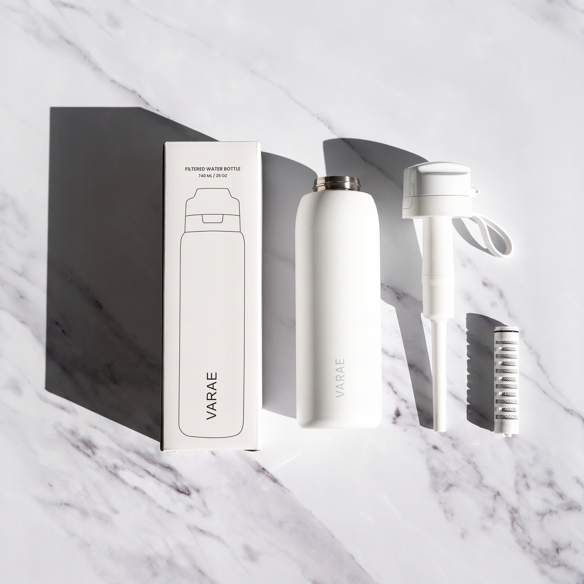 What's in the box: VARAE Pure bottle, lid with carry loop and straw, and filter cartridge beside the printed box