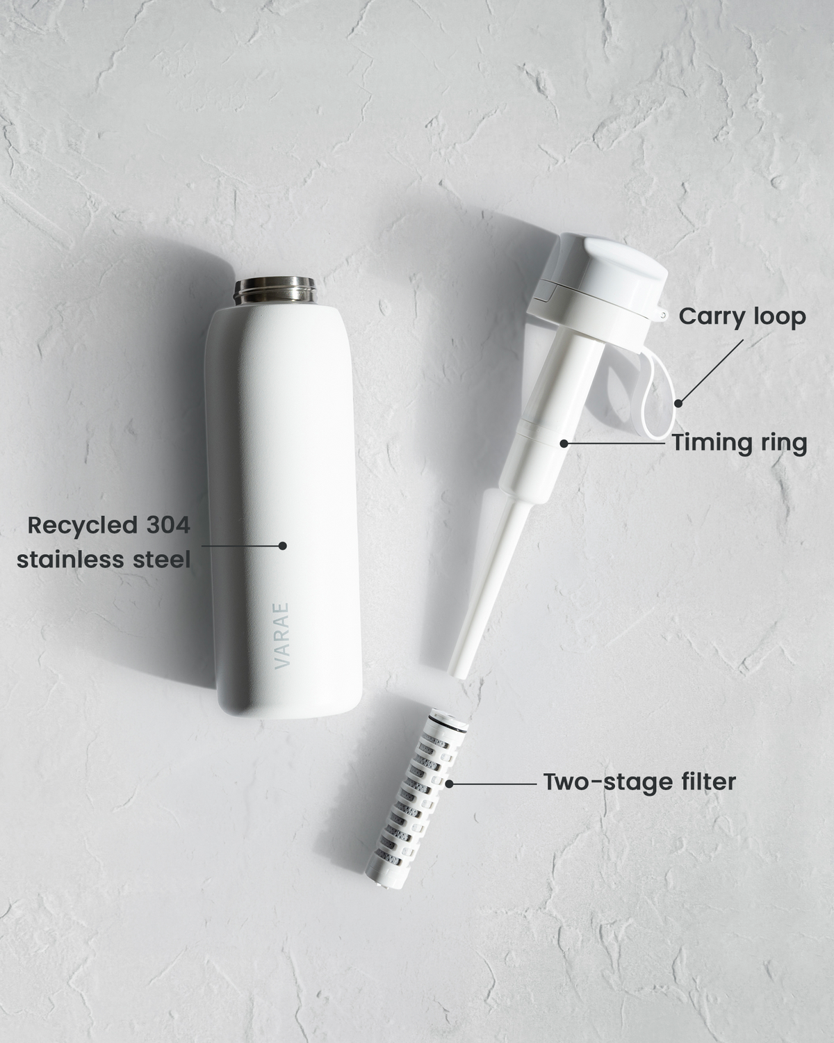 VARAE Pure bottle disassembled, showing the recycled stainless steel body, lid with carry loop and timing ring, and the two-stage filter